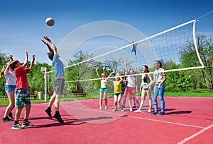 Jumping boy during volleyball game on the court