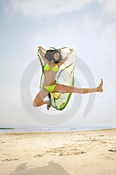 Jumping with Brazil flag on beach