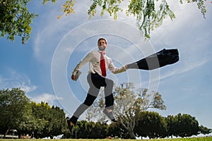 Jumping businessman in park. Fast business concept.