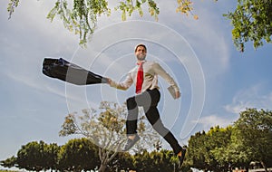 Jumping businessman in park. Fast business concept.