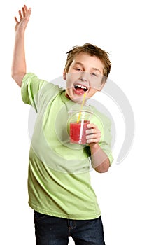 Jumping child holding healthy fruit juice