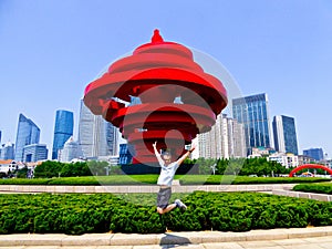 Jumping in front of May Wind sculpture