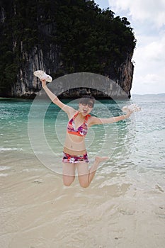 Jumping girl at the beach