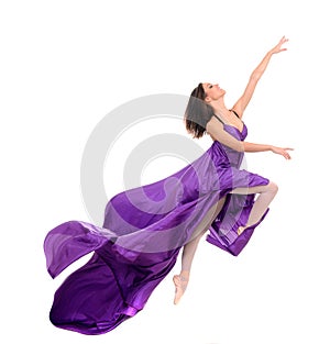 Jumping girl dancer in flying purple dress