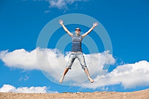 Jumping girl with hands up against