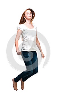 Jumping girl in a white T-shirt. Isolated on white background