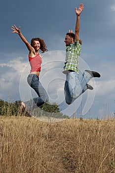 Jumping happy young couple