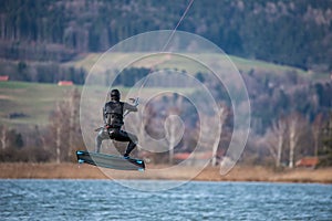 Jumping Kitesurfer with high speed on the water
