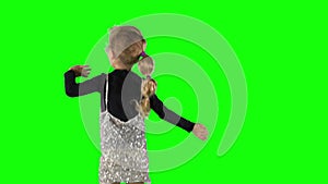 Jumping little girl in glisten dress over chroma key even green background