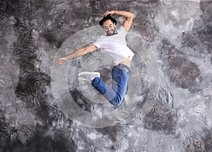 Jumping male dancer against grunge wall