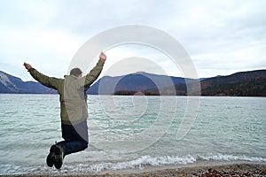 Jumping man with lake