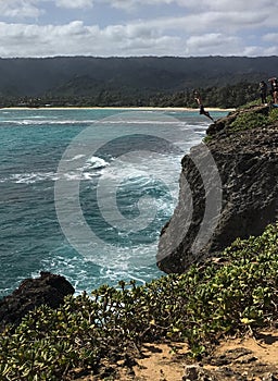 Jumping off the cliff at Laie Point, North Short