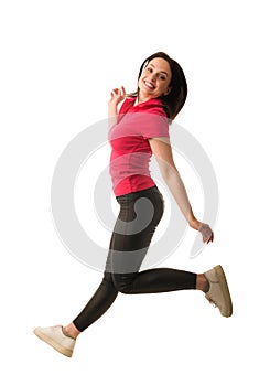 jumping pretty young woman in red or pink shirt isolated on white background