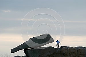 Jumping from the rocks of the Pink Granite Coast in Bretagne