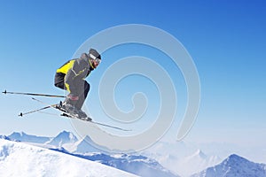 Jumping skier at mountains