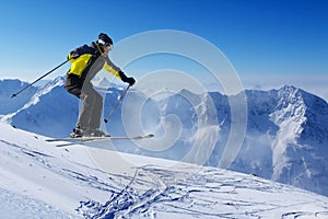 Jumping skier at mountains