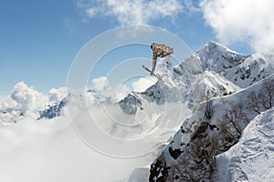 Jumping skier in mountains. Extreme sport, freeride.