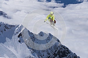 A jumping skier in the mountains. Mountain ski, winter extreme sport.