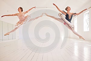 Jumping team of female ballerinas, leaping ballet girls or performers in traditional tutu dress costume in the studio