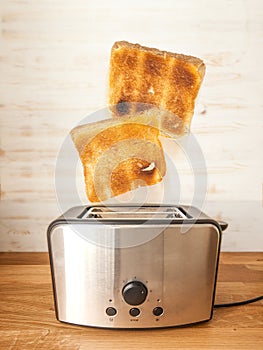 Jumping toasts. Preparing breakfast in modern toaster