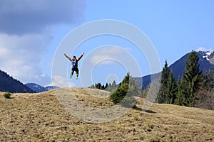 Jumping up in front of the mountains