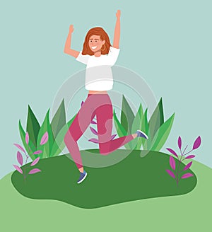 Jumping woman in the meadow with foliage