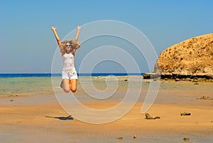 Jumping woman on the seaside