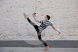 Jumping young buinessman in front of buildings, on the run in jump high