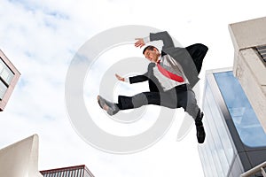 Jumping young business man