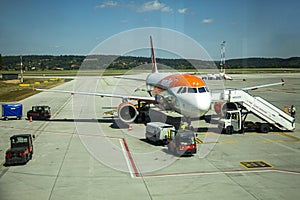 Jun 11 2021: Milan, Italy - airplane is parked on the runway of the airport, awaiting its passengers