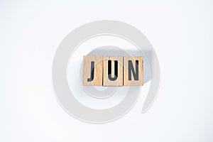 ` JUN ` text made of wooden cube on  White background