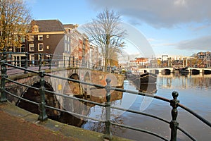 The junction between Amstel river and Prinsengracht Canal, with Skinny Bridge Magere Brug in the background