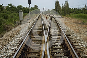 Junction of railway track with green tree at left and right side of railway.filtered image.choose for life concept.choice of life