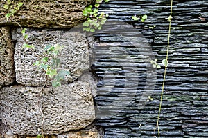 Junction of walls with two different textures. Layers of uneven