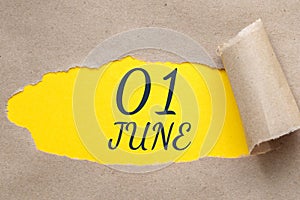 june 01. 01th day of the month, calendar date.Hole in paper with edges torn off. Yellow background is visible through