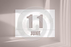 june 11. 11th day of the month, calendar date.White sheet of paper with numbers on minimalistic pink background with