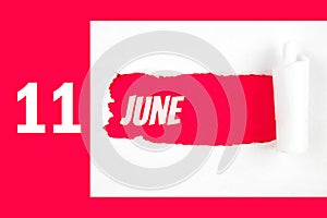 June 11st . Day 11 of month, Calendar date. Red Hole in the white paper with torn sides with calendar date. Summer month, day of