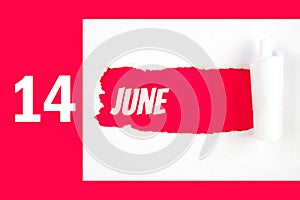 June 14th. Day 14 of month, Calendar date. Red Hole in the white paper with torn sides with calendar date. Summer month, day of