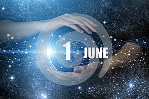 June 1st . Day 1 of month, Calendar date. Human holding in hands earth globe planet with calendar day. Elements of this image