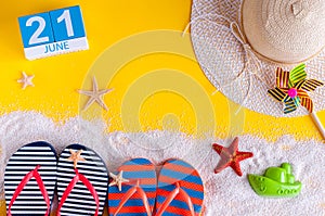 June 21st. Image of june 21 calendar on yellow sandy background with summer beach, traveler outfit and accessories