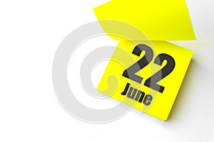 June 22nd. Day 22 of month, Calendar date. Close-Up Blank Yellow paper reminder sticky note on White Background. Summer month, day