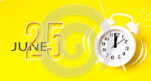 June 25th. Day 25 of month, Calendar date. White alarm clock with calendar day on yellow background. Minimalistic concept of time