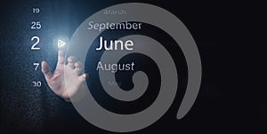 June 2nd. Day 2 of month, Calendar date. Hand click luminous icon PLAY and DATE on dark blue background. Summer month, day of the