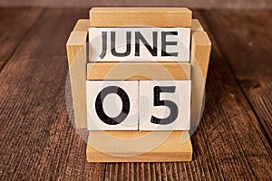 June 5th. Wooden cubes with date of 5 June on old blue wooden background.