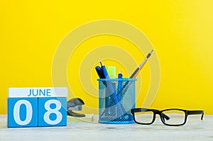 June 8th. Day 8 of month, calendar on yellow background with office suplies. Summer time at work. International Cleanup