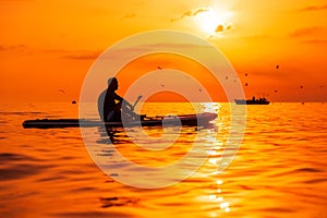 June 21, 2021. Antalya, Turkey. Man on stand up paddle board at ocean with bright sunset. Vacation on sup board in sea