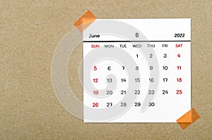 June 2022 calendar on brown background photo