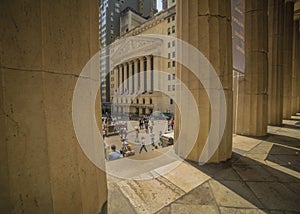 JUNE 7, 2018 - New York, New York, USA - New York Stock Exchange Exerior with US Flags - as seen through columns of Federal Hall