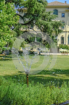 June 2021 Parma, Italy: Fondation Magnani Rocca. Beautiful building of museum across garden and fountain with bubbling water