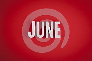 June sign lettering on red background